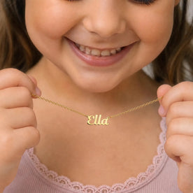 Child holding gold Ella name necklace - Bella font