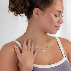 Model wearing vermeil double name necklace with solid heart saying Rosie and Faye on anchor chain - Zara font