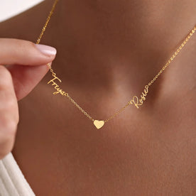 Model wearing gold Freya and Rosie double name with solid heart on anchor chain - Anna font - Zara font