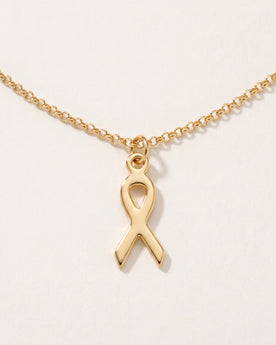 Free gift Ribbon Charm in gold on a belcher chain