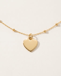 Collar y pulsera con dije de corazón sólido