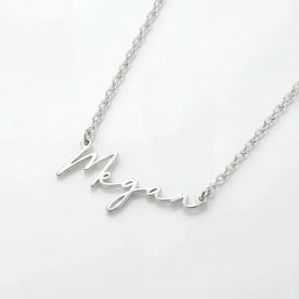 Close up of Silver Kids Personalised Megan Name Necklace - Ruby font