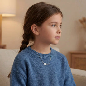 Girl wearing a Silver Olivia name necklace - Anna font