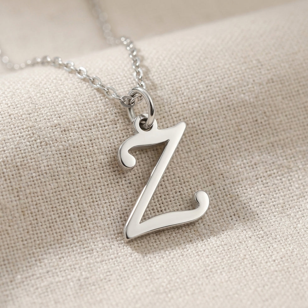 Personalised silver initial necklace with the letter Z in the Zara style, close up, showing the polished cut edge and the thickness of the metal.
